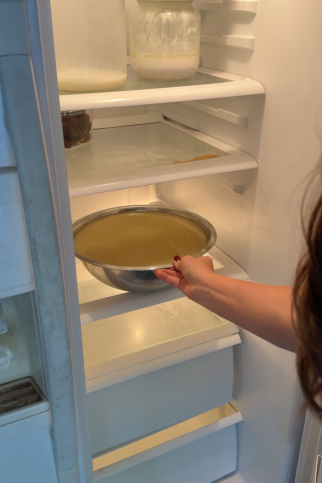 Refrigerating homemade chicken stock.